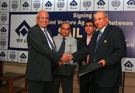  SAIL Chairman Mr. S.K. Roongta (extreme left) and SCI Chairman Mr. S. Hajara exhanging copies of the agreement for formation of a shipping joint venture company by SAIL and SCI. The signatories to the agreement are seen at the centre: SAIL Director (Finance) Mr. Soiles Bhattacharya (left) and SCI Director (Technical & Off-shore Services) Mr. U.C. Grover.